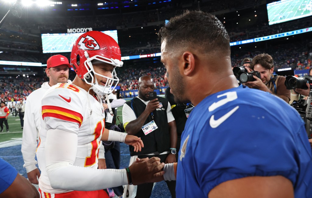 Kansas City Chiefs quarterback Patrick Mahomes and New York Giants quarterback Russell Wilson shaking hands on the field.