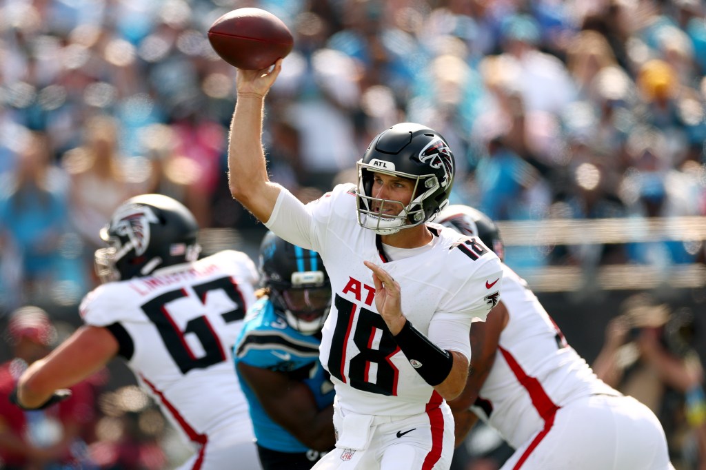 Kirk Cousins, wearing an Atlanta Falcons uniform, throws a football during a game against the Carolina Panthers.