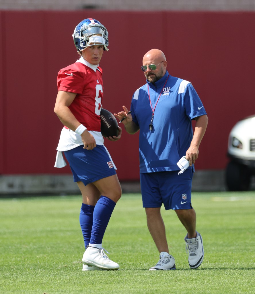 Giants head coach Brian Daboll speaking to quarterback Jaxson Dart #6, during practice at the New York Giants training facility in East Rutherford, New Jersey.