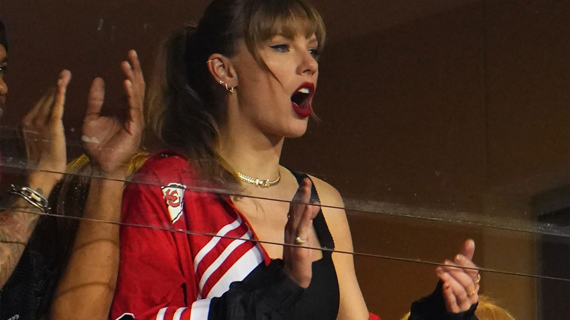 Taylor Swift wears a KC jacket while watching the Kansas City Chiefs play the Denver Broncos