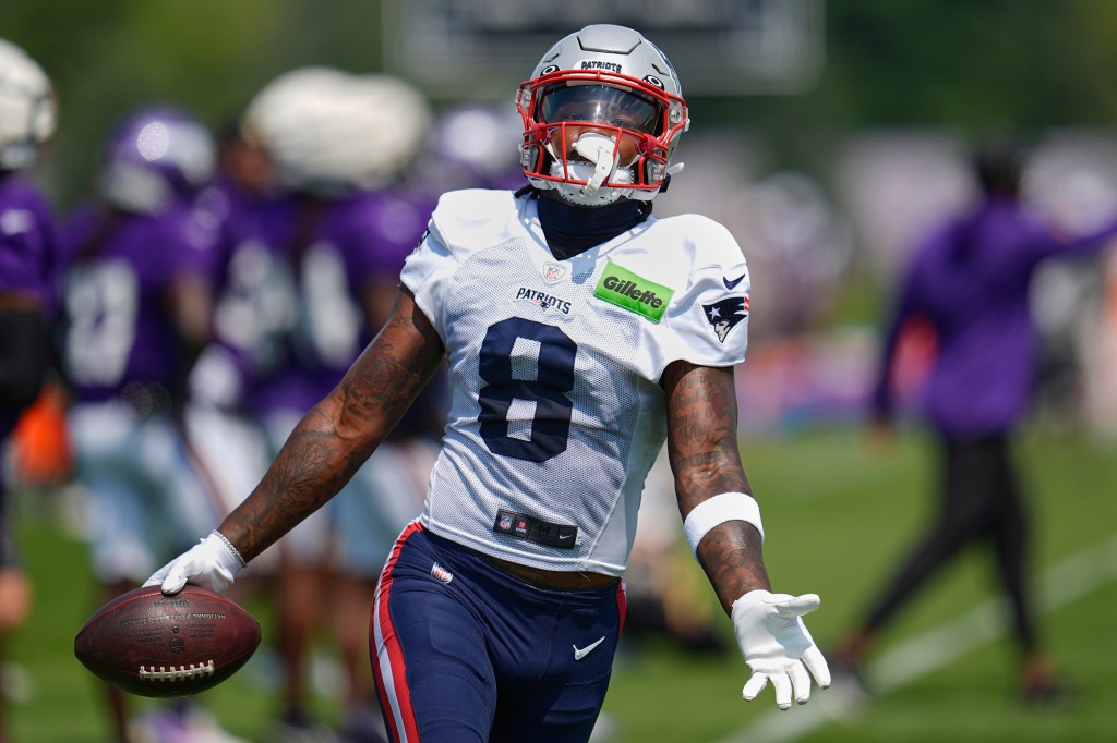 New England Patriots football player holding a football.