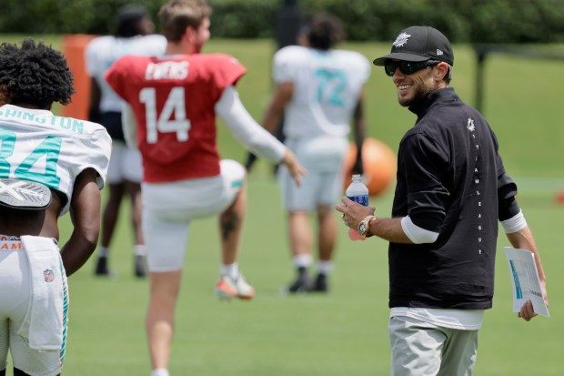 Miami Dolphins coach Mike McDaniel looks over the team during...