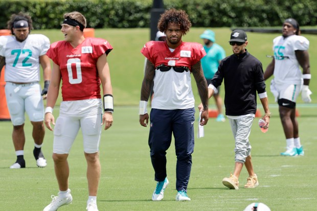 Miami Dolphins quarterback Tua Tagovailoa warms up during practice on...