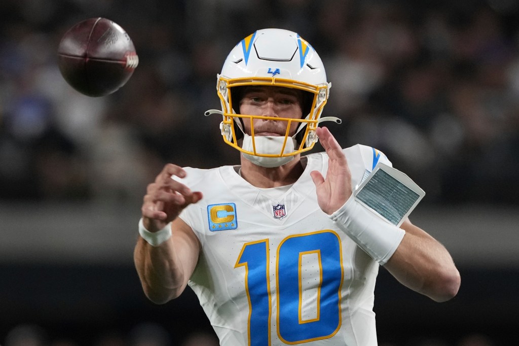 Justin Herbert, Los Angeles Chargers quarterback, throwing a football.