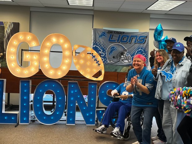 Shella Beaman, far right, and Rebecca Nehra gather for a photo during Wednesday's tailgate party at Henry Ford Macomb. GINA JOSEPH - THE MACOMB DAILY
