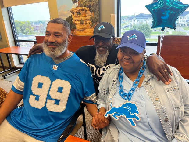 Enjoying Wednesday's event at Henry Ford Macomb Hospital in Clinton Township are Shella and Richard Beaman of Mount Clemens, posing for a photo with former Detroit Lions James Cribbs. GINA JOSEPH - THE MACOMB DAILY