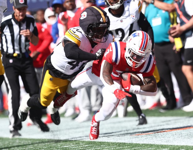 Foxboro, MA - New England Patriots wide receiver Demario Douglas is pushed out of bounds by Pittsburgh Steelers's Jabrill Peppers during the second quarter of the game at Gillette Stadium. (Nancy Lane/Boston Herald)