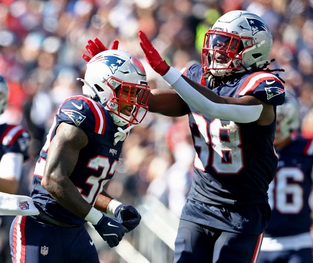 Foxboro, MA - New England Patriots' Rhamondre Stevenson celebrates the touchdown by Treveyon Henderson during the second quarter of the game at Gillette Stadium. (Nancy Lane/Boston Herald)