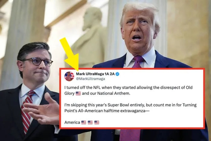 Two men in suits speak in a formal setting. One gestures while talking. They stand in front of large columns and a statue