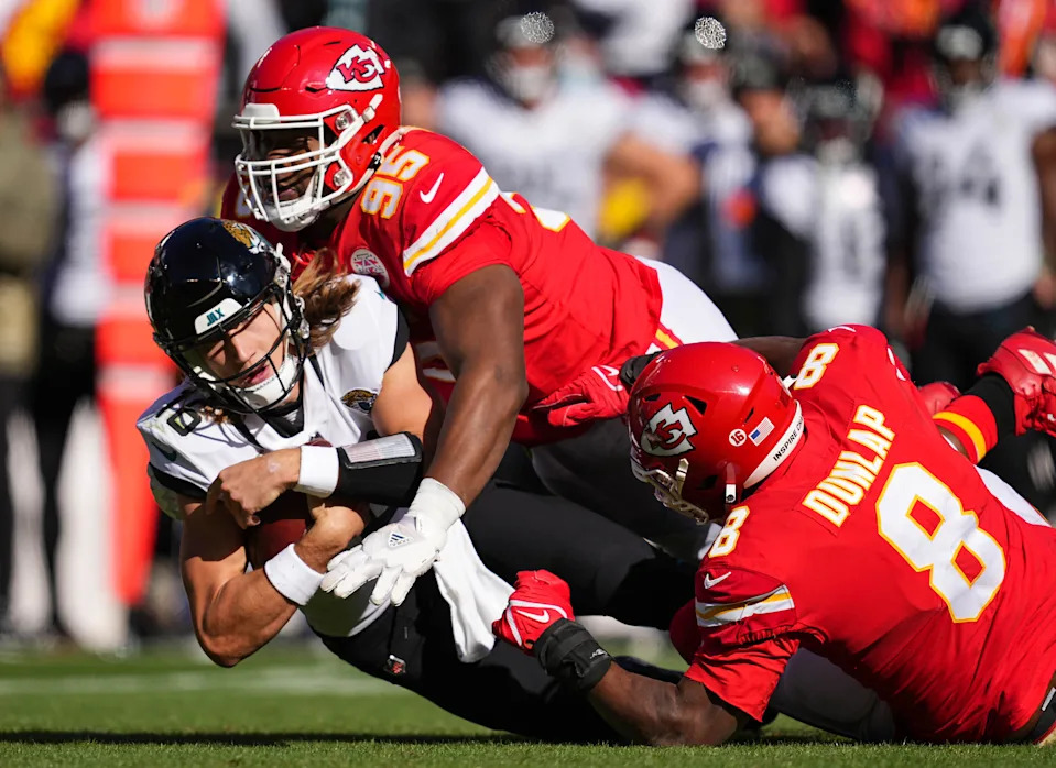 Nov 13, 2022; Kansas City, Missouri, USA; Jacksonville Jaguars quarterback Trevor Lawrence (16) is sacked by Kansas City Chiefs defensive tackle Chris Jones (95) and defensive end Carlos Dunlap (8) during the first half at GEHA Field at Arrowhead Stadium. Mandatory Credit: Jay Biggerstaff-USA TODAY Sports