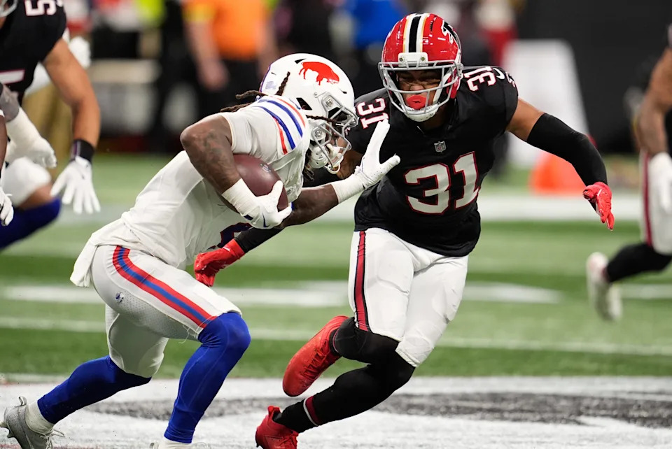 Oct 13, 2025; Atlanta, Georgia, USA; Buffalo Bills running back James Cook (4) takes on Atlanta Falcons safety Xavier Watts (31) during the first half of a game at Mercedes-Benz Stadium. Mandatory Credit: Dale Zanine-Imagn Images