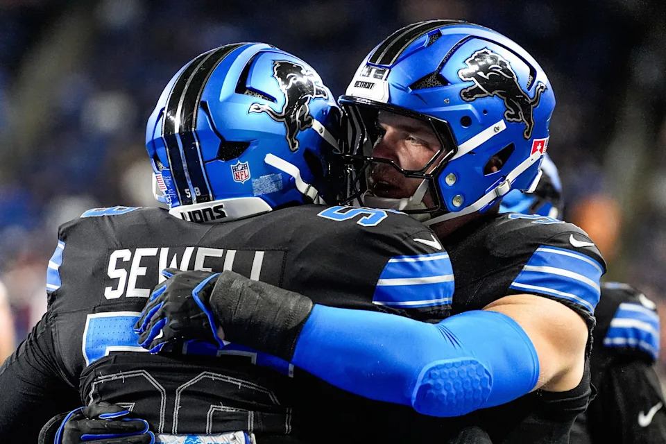 Detroit Lions defensive end Aidan Hutchinson (97) hugs offensive tackle Penei Sewell (58) during warm up ahead of the Tampa Bay Buccaneers game at Ford Field in Detroit on Monday, Oct. 20, 2025.
