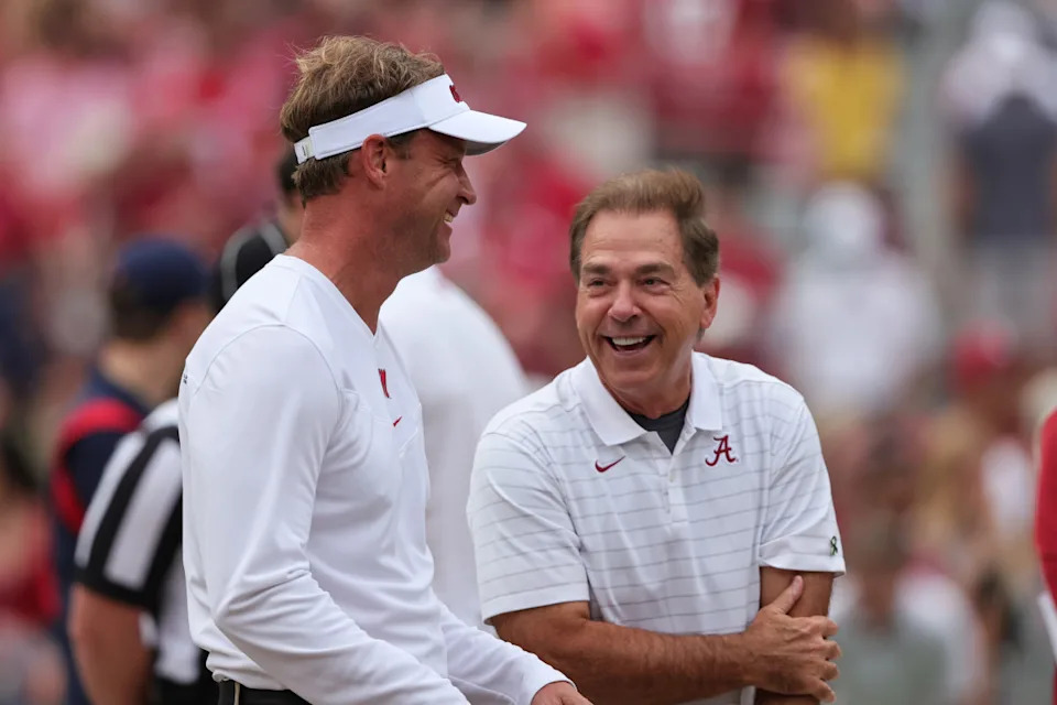Ole Miss Rebels head coach Lane Kiffin talks with former Alabama Crimson Tide head coach Nick Saban.© Butch Dill-Imagn Images