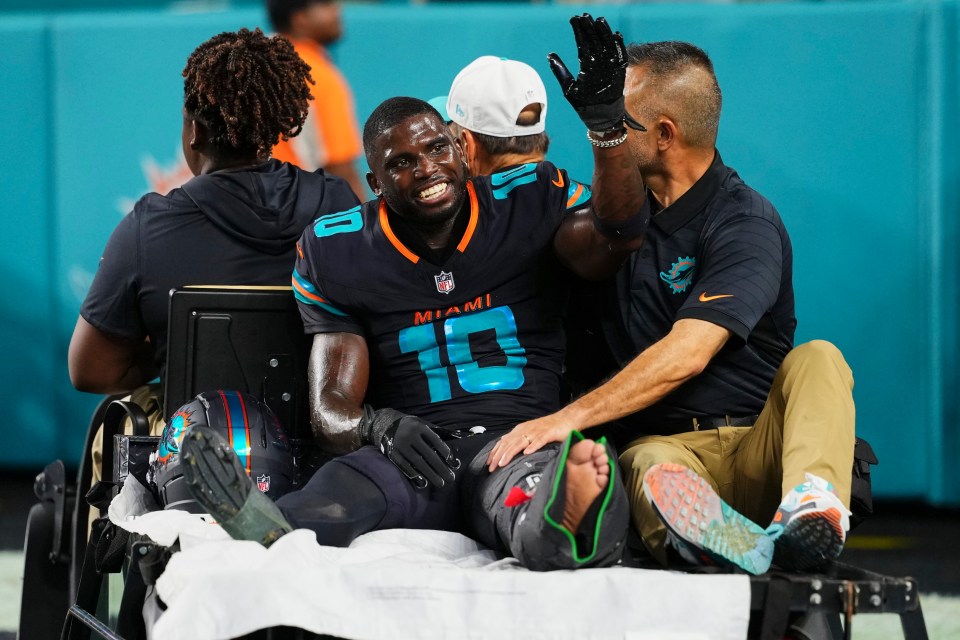 Tyreek Hill, a Miami Dolphins player, being carted off the field after an injury.