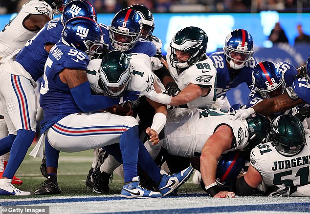 Jalen Hurts of the Philadelphia Eagles crosses the goal line for a touchdown on a tush push