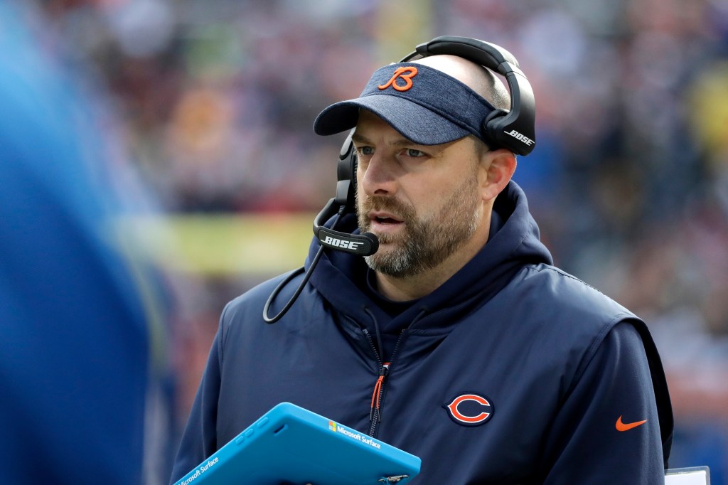 Matt Nagy wearing a Bears visor and headset while holding a Microsoft Surface tablet.