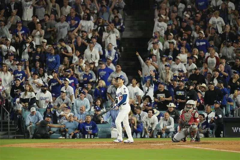 Shohei Ohtani celebrates after hitting a home run in the sixth inning, his second of the game, for the Dodgers in the National League wild card series game in Los Angeles.