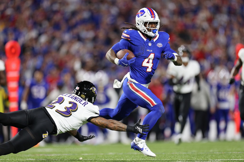 ORCHARD PARK, NEW YORK - SEPTEMBER 07: James Cook #4 of the Buffalo Bills carries the ball against Jaire Alexander #23 of the Baltimore Ravens during the fourth quarter at Highmark Stadium on September 07, 2025 in Orchard Park, New York.