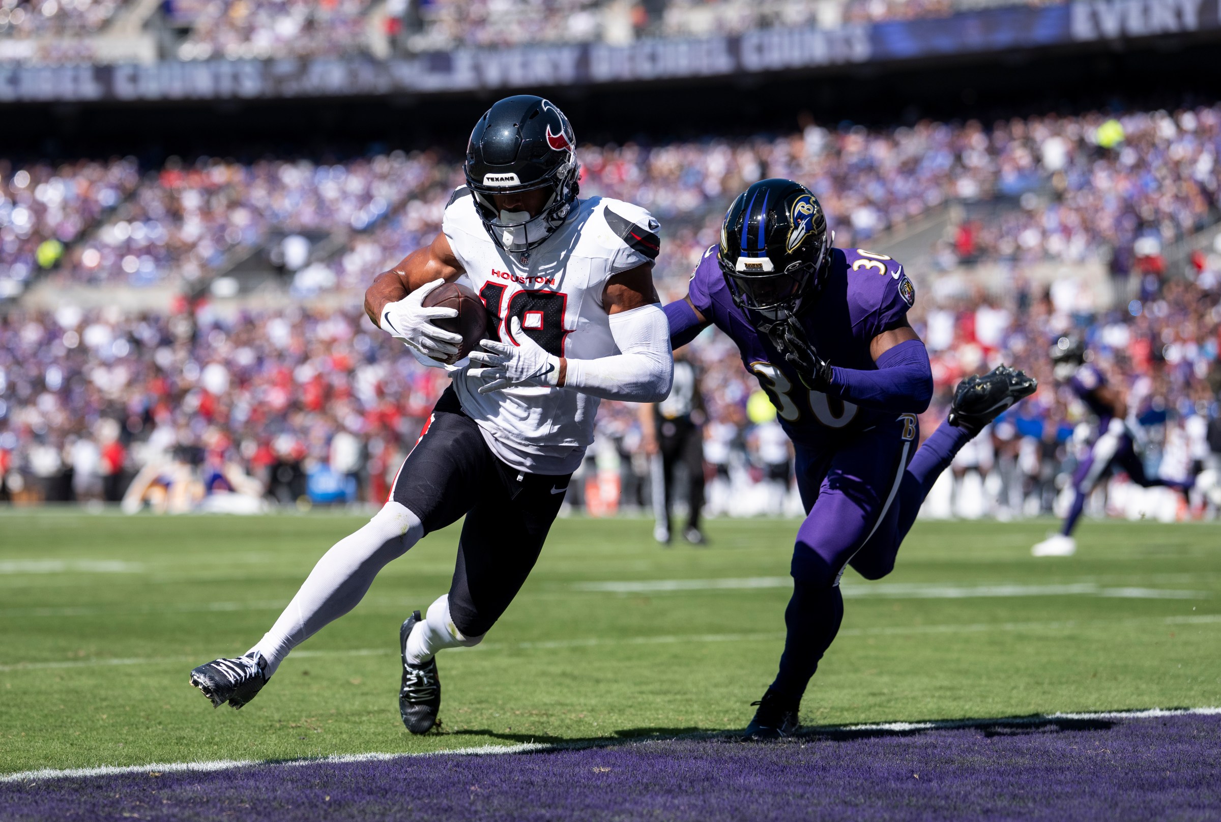 BALTIMORE, MARYLAND - OCTOBER 5: Xavier Hutchinson #19 of the Houston Texans runs with the ball and scores a touchdown during an NFL football game against the Baltimore Ravens at M&T Bank Stadium on October 05, 2025 in Baltimore, Maryland. (Photo by Michael Owens/Getty Images)