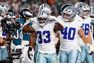 Dallas Cowboys running back Javonte Williams (33) flexes after scoring a touchdown during...