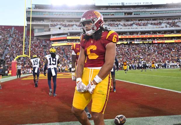 Wide receiver Makai Lemon #6 of the USC Trojans rea...