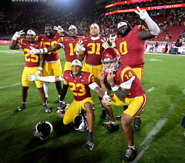 Quarterback Jayden Maiava #14 of the USC Trojans and teammates...