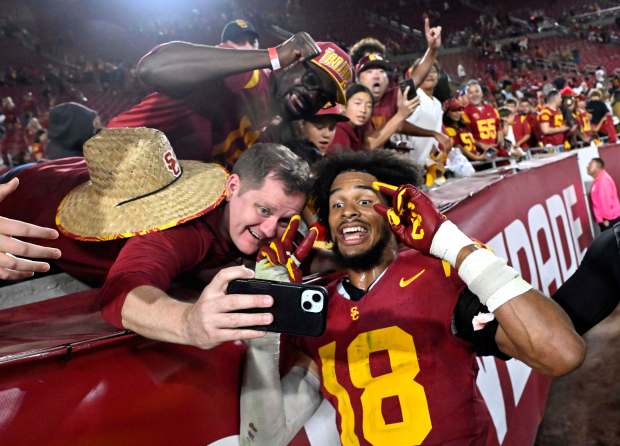 Linebacker Eric Gentry #18 of the USC Trojans celebrates after...