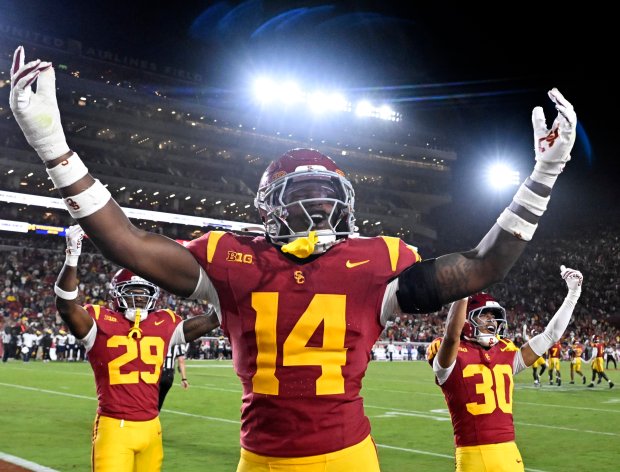 Linebacker Ta’Mere Robinson #14 of the USC Trojans reacts after...