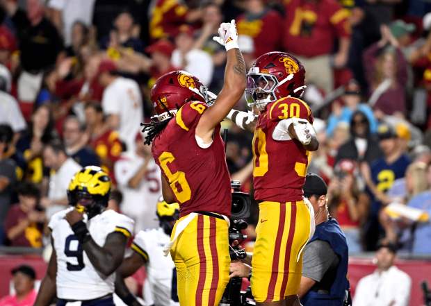 Running back King Miller #30 of the USC Trojans celebrates...