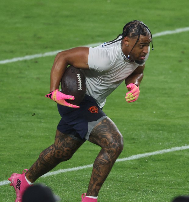 Bears cornerback Kyler Gordon warms up for a game against...