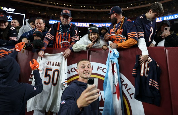Chicago Bears quarterback Tyson Bagent takes a photo with fans...