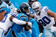 Carolina Panthers running back Rico Dowdle (5) is tackled by Dallas Cowboys linebacker...