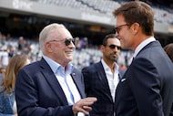 Dallas Cowboys Owner Jerry Jones, left, speaks to Tom Brady before an NFL football game...