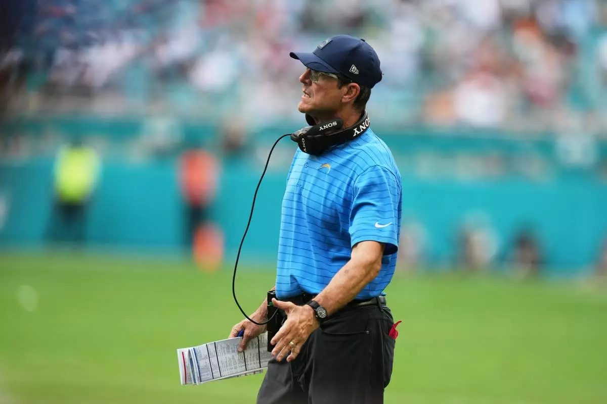 Los Angeles Chargers head coach Jim Harbaugh looks on during the first half of an NFL football game against the Miami Dolphins Sunday, Oct. 12, 2025, in Miami Gardens, Fla. (AP Photo/Lynne Sladky)