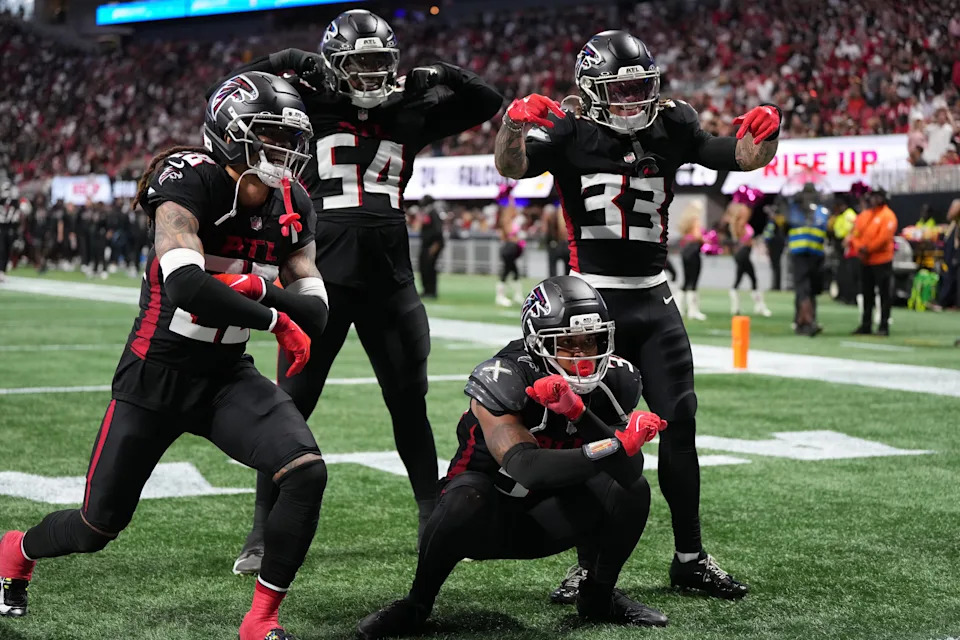 Sep 28, 2025; Atlanta, Georgia, USA; Atlanta Falcons safety Xavier Watts (31) celebrates with cornerback Mike Ford (28), defensive end Brandon Dorlus (54) and safety Billy Bowman Jr. (33) after a play during the second half against the Washington Commanders at Mercedes-Benz Stadium. Mandatory Credit: Dale Zanine-Imagn Images