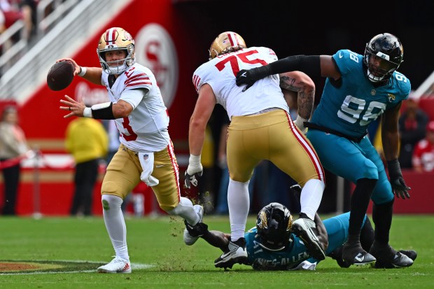Jacksonville Jaguars defensive end Josh Hines-Allen (41) gets a hold of San Francisco 49ers quarterback Brock Purdy (13) as he is pressured to throw the ball in the second quarter of their NFL game at Levi's Stadium in Santa Clara, Calif., on Sunday, Sept. 28, 2025. (Jose Carlos Fajardo/Bay Area News Group)