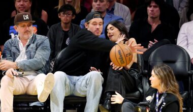 Chargers' Justin Herbert protects Madison Beer from basketball at Lakers game