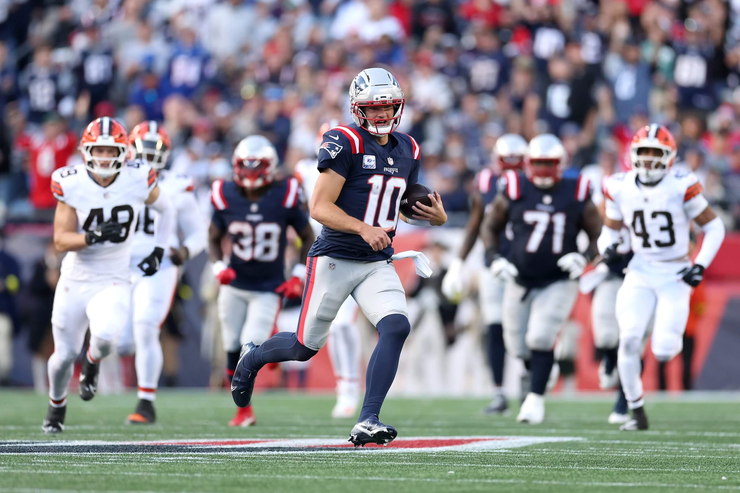 Drake Maye runs with the ball during New England's win over the Browns.