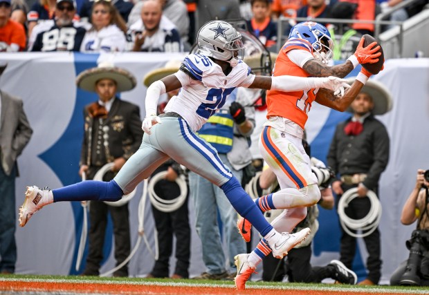 Pat Bryant (13) of the Denver Broncos hauls in a touchdown reception over Trikweze Bridges (25) of the Dallas Cowboys during the second quarter at Empower Field at Mile High in Denver on Sunday, Oct. 26, 2025. (Photo by AAron Ontiveroz/The Denver Post)