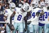 Dallas Cowboys safety Donovan Wilson (6) celebrates with teammates after intercepting a pass...