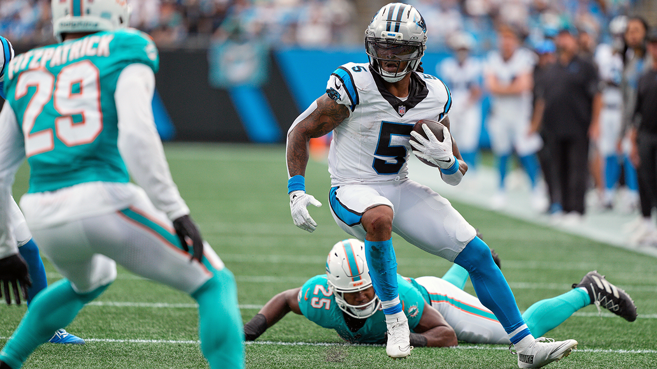 Panthers running back Rico Dowdle runs past Dolphins linebacker Tyrel Dodson for some of his career-high 206 yards.