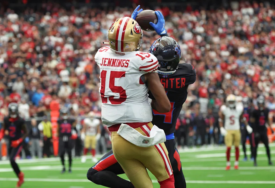 Houston Texans cornerback Kamari Lassiter intercepts a pass intended for San Francisco 49ers wide receiver Jauan Jennings.