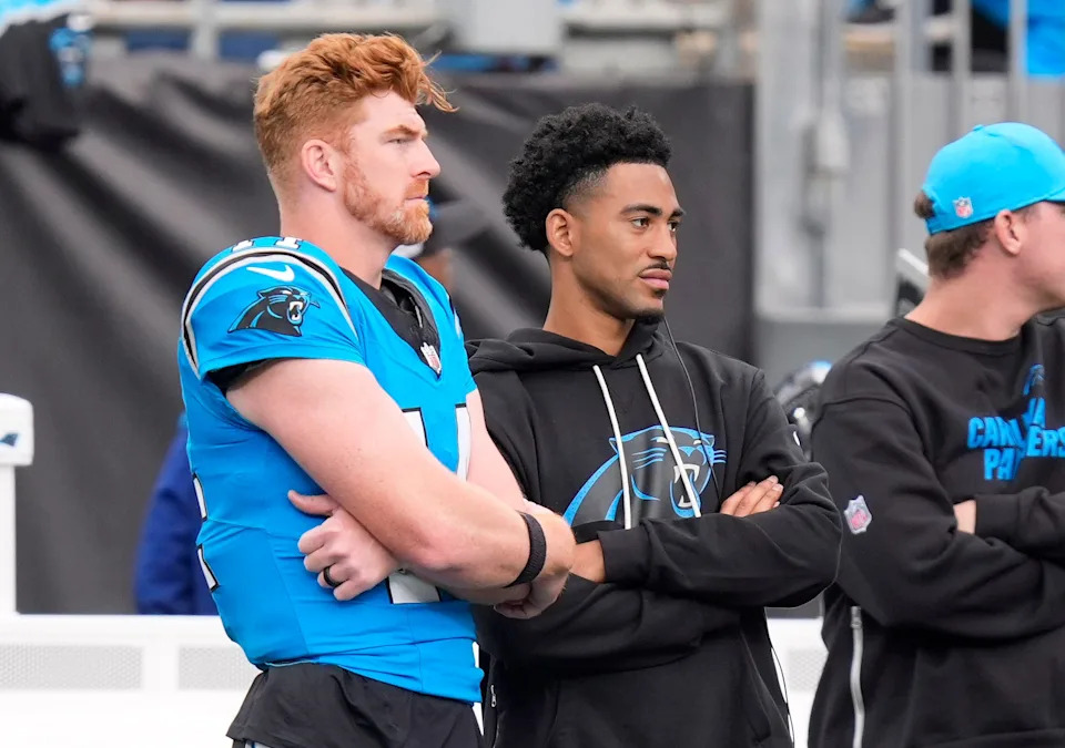 Carolina Panthers quarterbacks Andy Dalton (14) and Bryce Young (9) on the sideline.