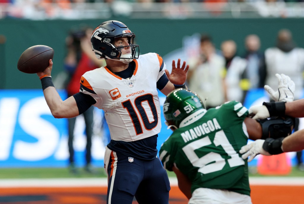 Denver Broncos' Bo Nix in action with New York Jets' Kiko Mauigoa.