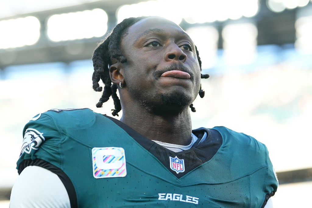 An NFL player in an Eagles jersey sticking out his tongue.