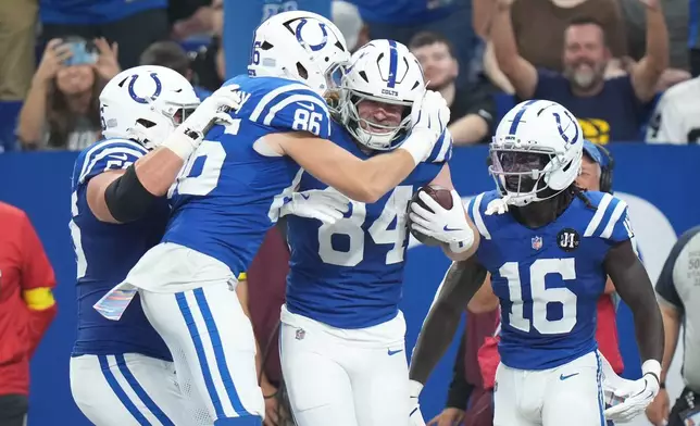 Indianapolis Colts tight end Tyler Warren (84) celebrates a touchdown catch with tight end Will Mallory (86) during the first half of an NFL football game against the Las Vegas Raiders, Sunday, Oct. 5, 2025, in Indianapolis. (AP Photo/AJ Mast)