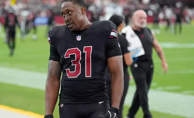 Arizona Cardinals running back Emari Demercado (31) reacts on the sideline after fumbling the ball out of the end zone on a touchdown run during the second half of an NFL football game against the Tennessee Titans, Sunday, Oct. 5, 2025, in Glendale, Ariz. (AP Photo/Ross D. Franklin)
