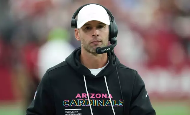 Arizona Cardinals head coach Jonathan Gannon walks the sideline during the first half of an NFL football game against the Tennessee Titans, Sunday, Oct. 5, 2025, in Glendale, Ariz. (AP Photo/Ross D. Franklin)