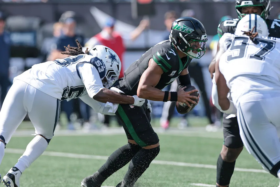 Oct 5, 2025; East Rutherford, New Jersey, USA; New York Jets quarterback Justin Fields (7) is sacked by Dallas Cowboys defensive end James Houston (53) during the first half at MetLife Stadium. Mandatory Credit: Vincent Carchietta-Imagn Images