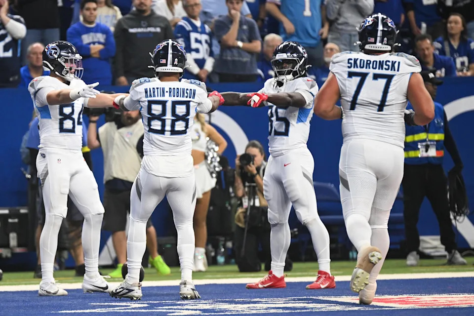 Tennessee Titans tight end Gunnar Helm (84) celebrates withChig Okonkwo (85) and David Martin-Robinson (88) after scoring a touchdown.